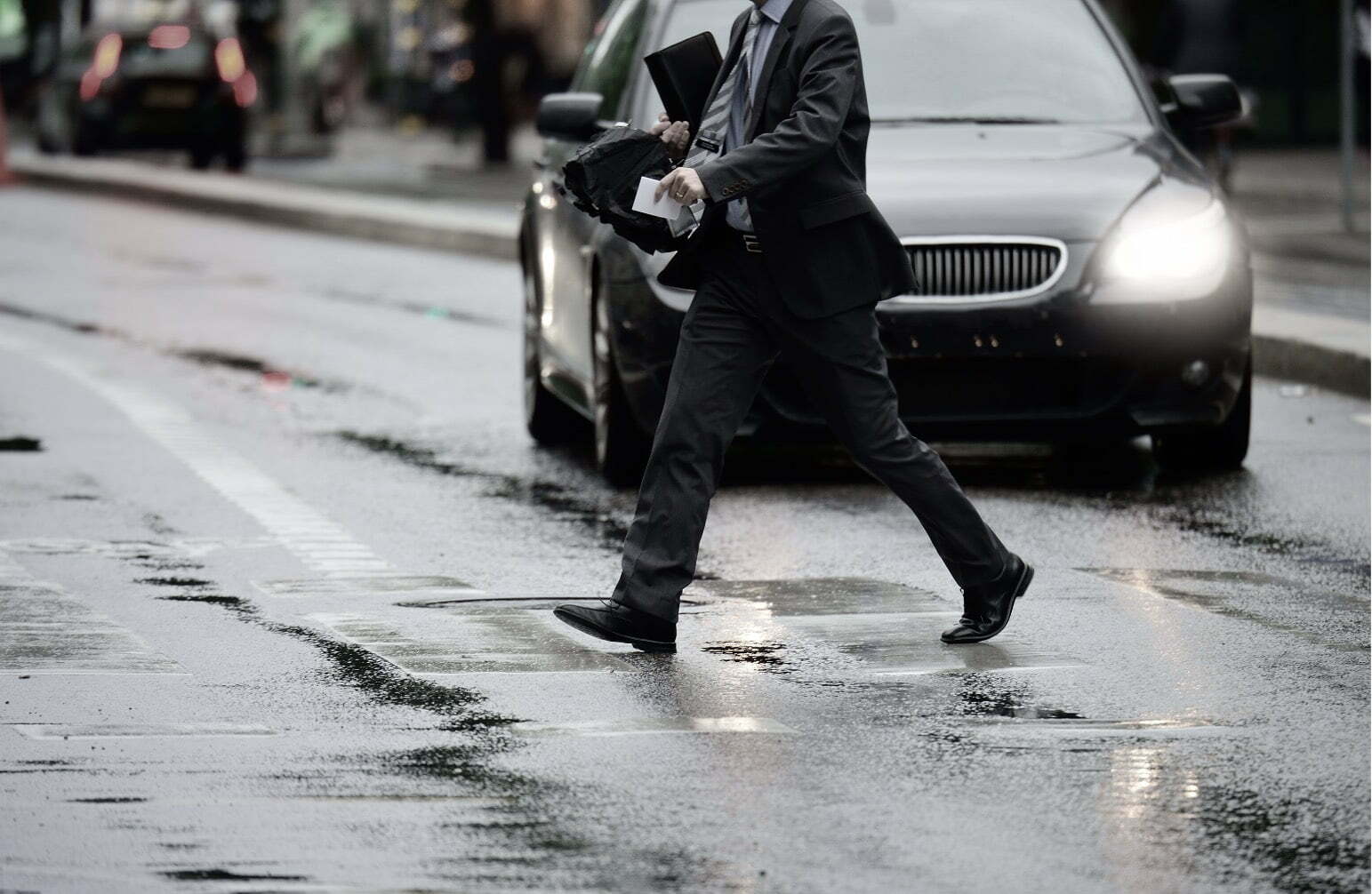 man in suit crossing the road