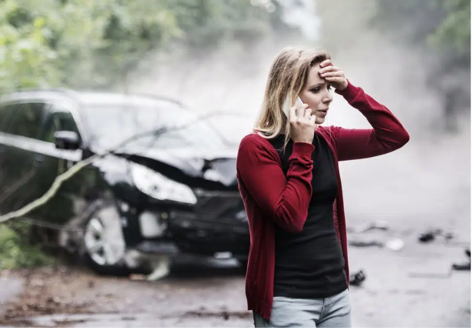 car crash behind a woman