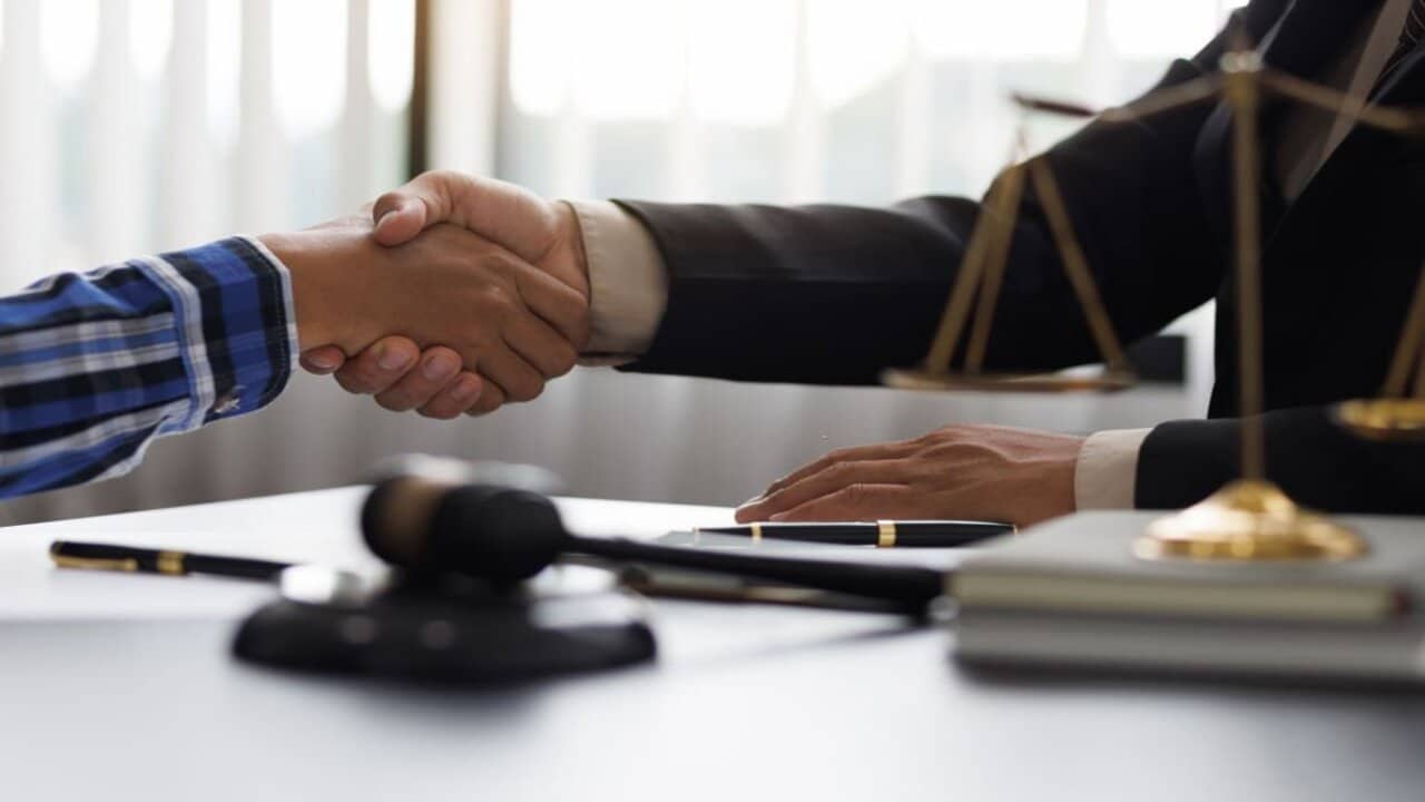 Lawyer Handshaking with His Client After Giving Him a Legal Advice