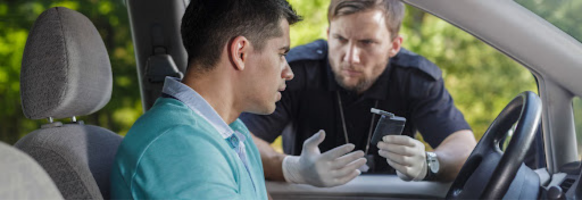 Washington State Patrol officer questioning a driver during a traffic stop for reckless driving and DUI suspicion.